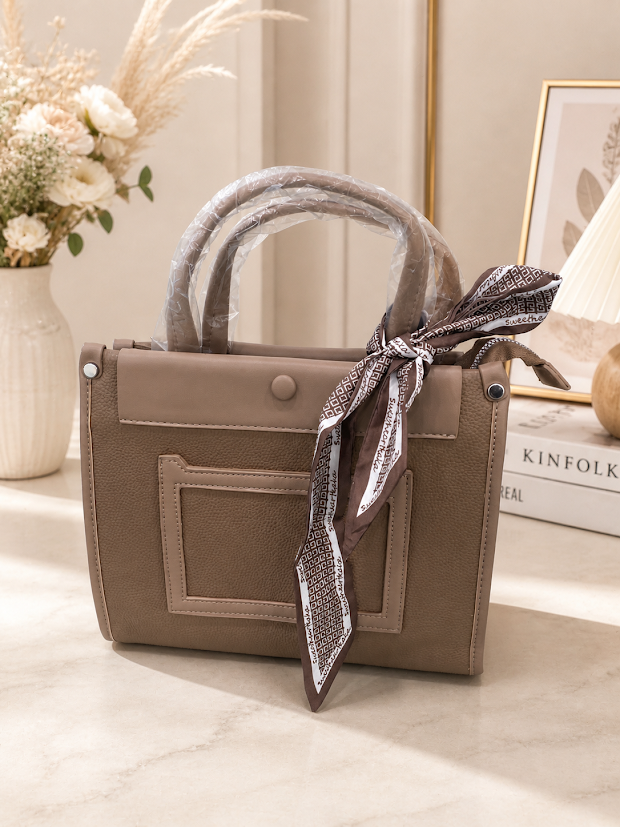 mauve colored handbag with a beautiful satin ribbon