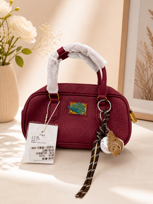 maroon sling bag with a cute accessory